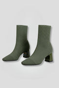 Woman wearing olive green ribbed stretch ankle boots - studio photo