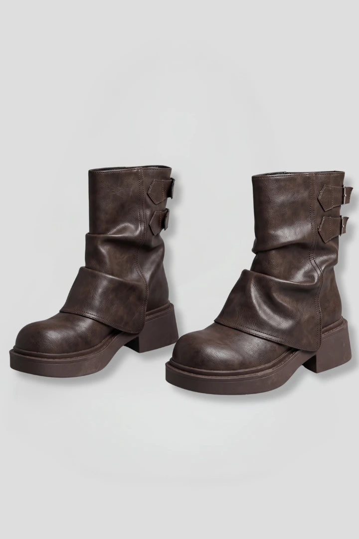 Woman wearing brown side buckle accent fall boots - studio photo