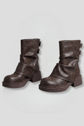 Woman wearing brown side buckle accent fall boots - studio photo