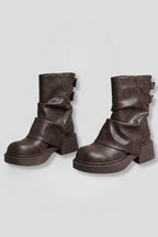Woman wearing brown side buckle accent fall boots - studio photo