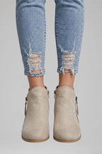 Woman wearing beige suede side zipper ankle boots - lifestyle photo
