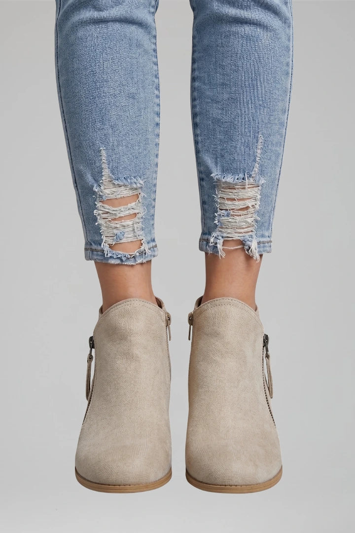 Woman wearing beige suede side zipper ankle boots - lifestyle photo