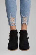 Woman wearing black suede side zipper ankle boots - lifestyle photo