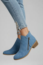 Woman wearing blue suede side zipper ankle boots - lifestyle photo