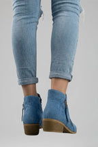Woman wearing blue suede side zipper ankle boots - lifestyle photo