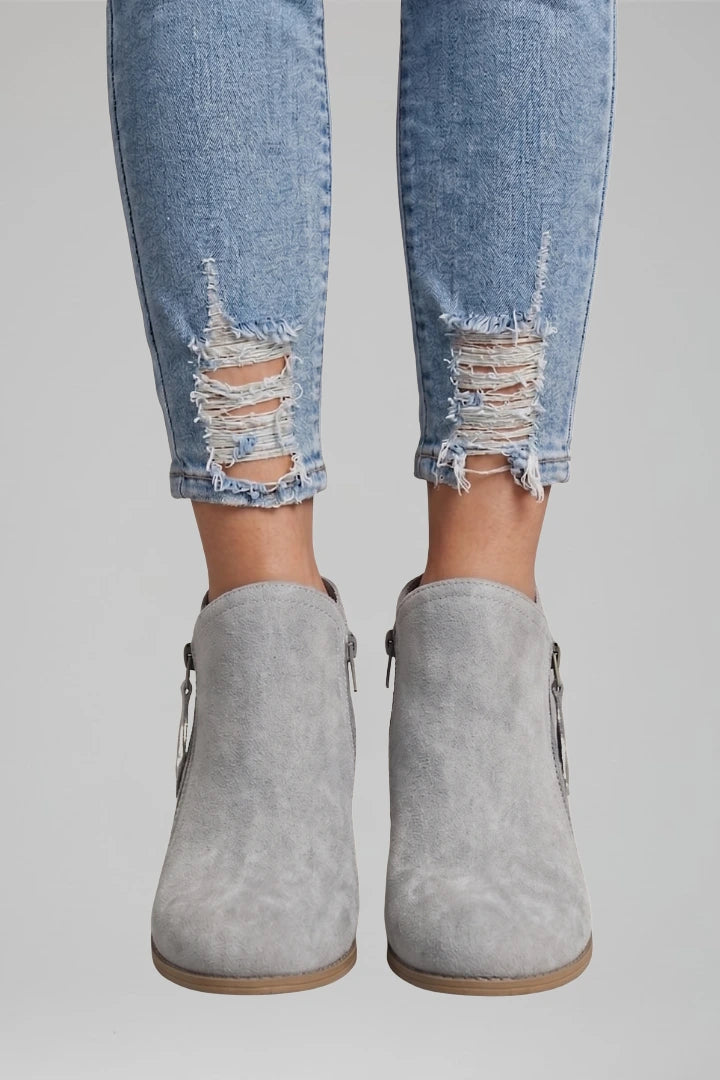 Woman wearing gray suede side zipper ankle boots - lifestyle photo
