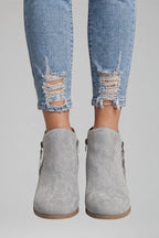 Woman wearing gray suede side zipper ankle boots - lifestyle photo