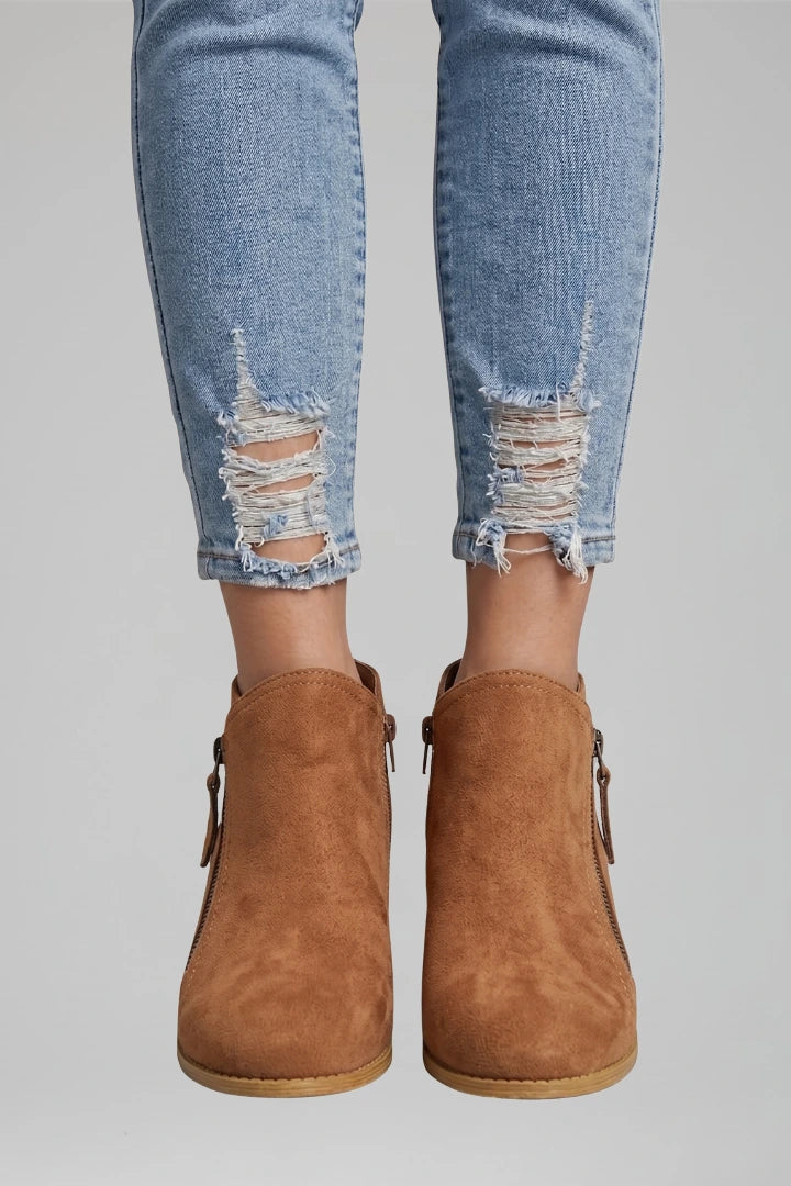 Woman wearing orange suede side zipper ankle boots - lifestyle photo