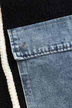 Close-up of denim patch pocket detail on black cardigan