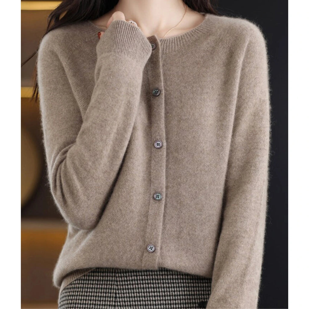 Woman wearing a brown wool cashmere button-up cardigan in a studio setting