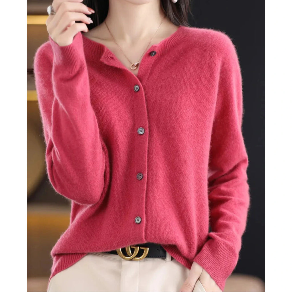 Woman wearing a hot pink wool cashmere button-up cardigan in a studio setting