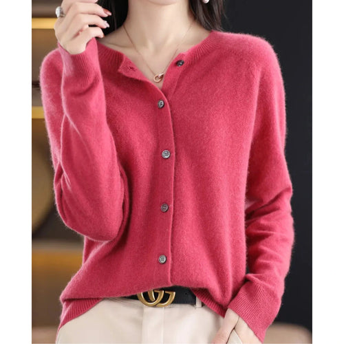 Woman wearing a hot pink wool cashmere button-up cardigan in a studio setting