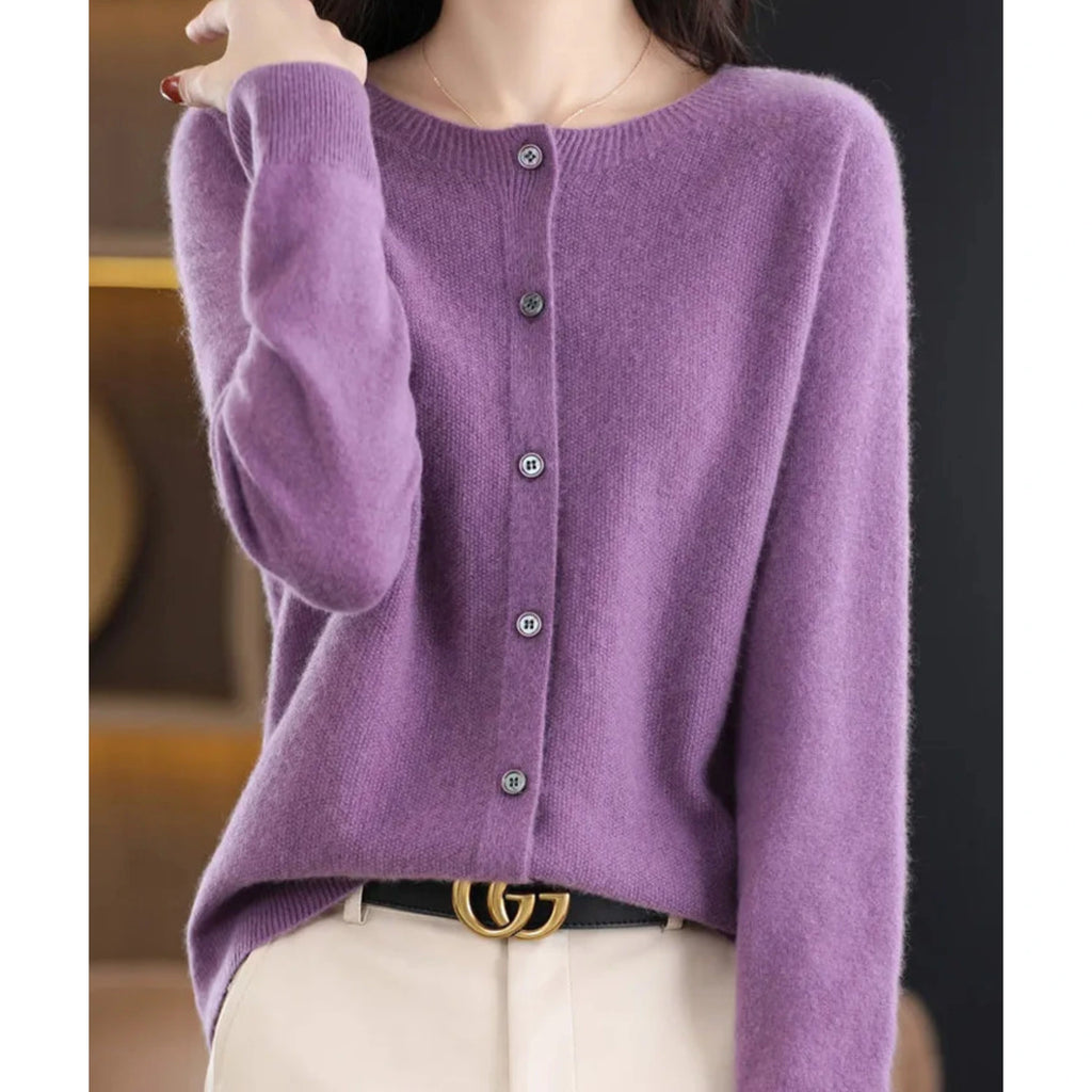 Woman wearing a purple wool cashmere button-up cardigan in a studio setting
