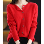 Woman wearing a red wool cashmere button-up cardigan in a studio setting