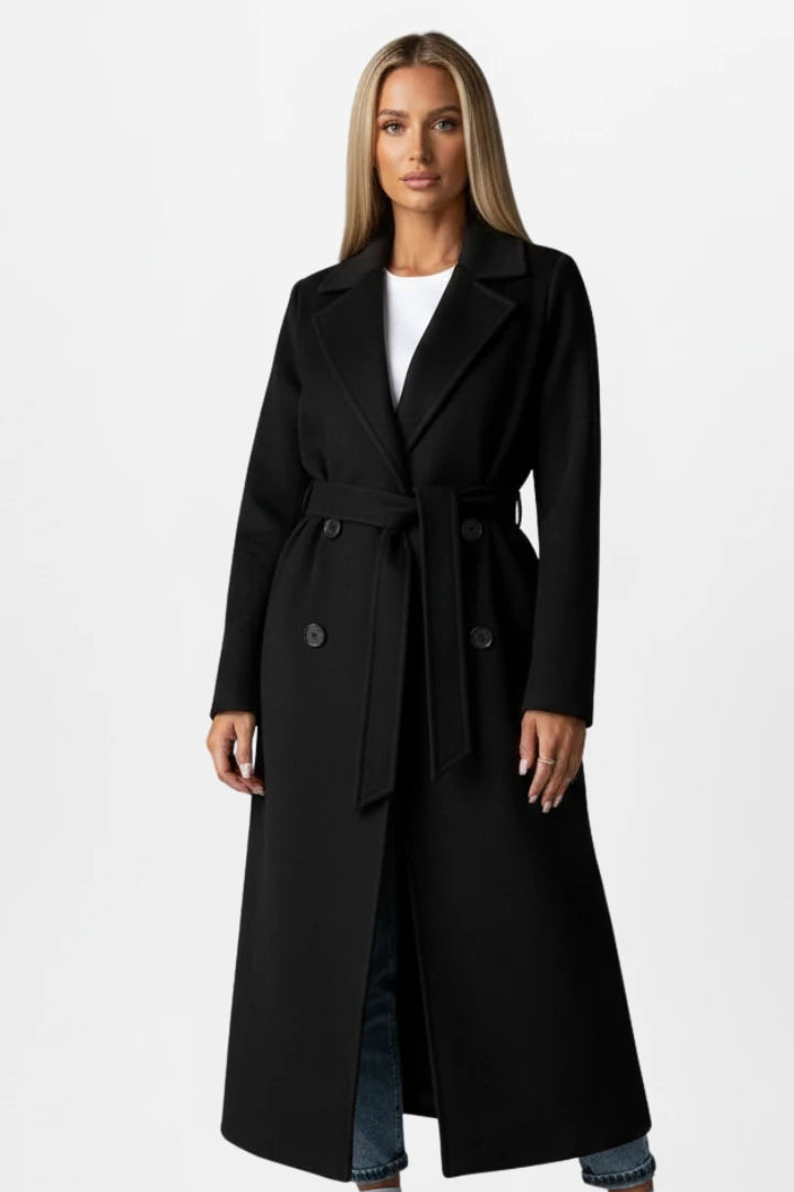 Woman wearing a black double-breasted belted long coat - studio photo