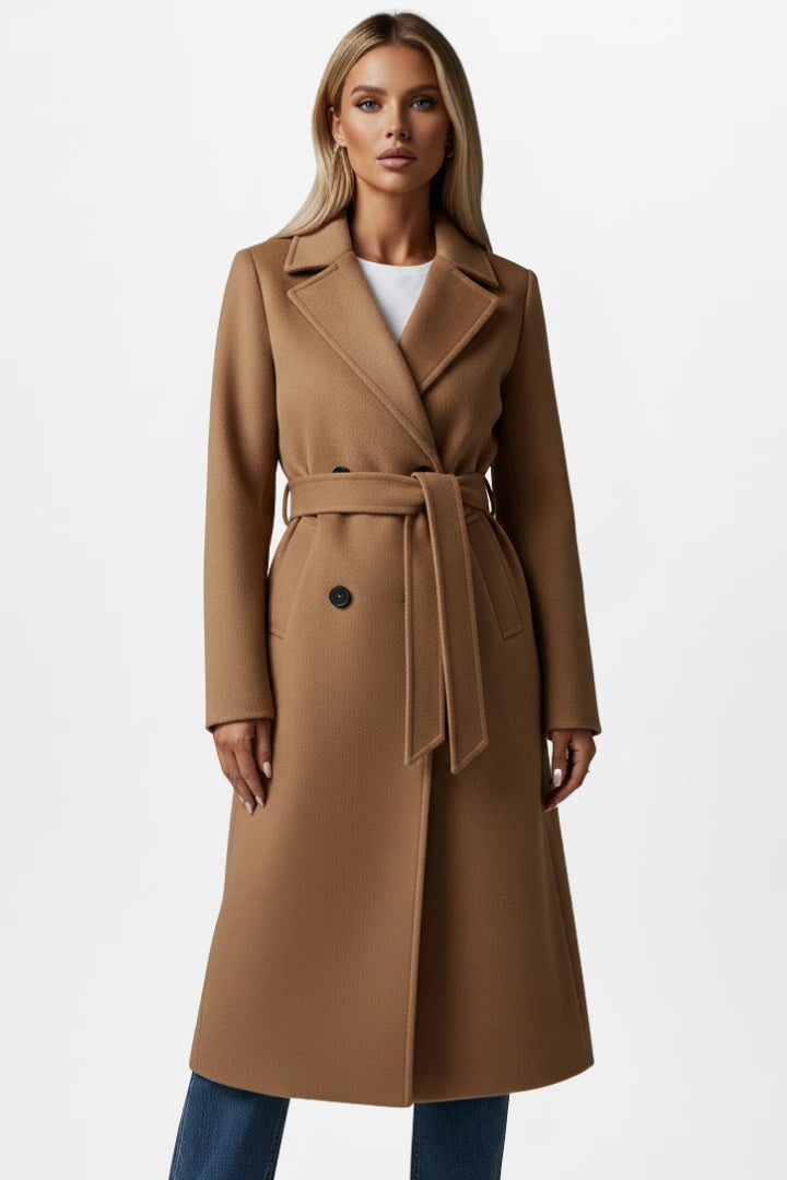 Woman wearing a camel double-breasted belted long coat - studio photo