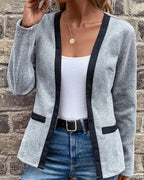 Driftly grey knitted coat with contrast black trim, angled view