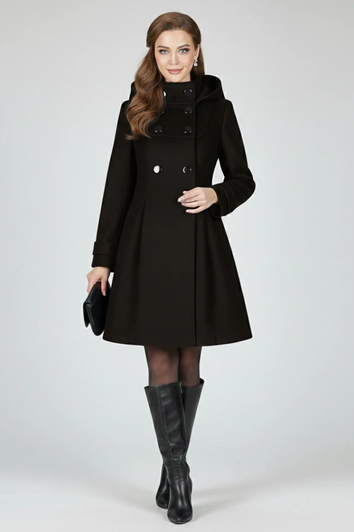 Woman wearing a black hooded double button-front coat - studio photo