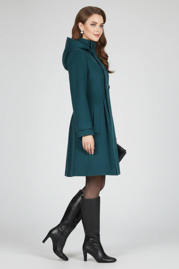 Woman wearing a green hooded double button-front coat - studio photo