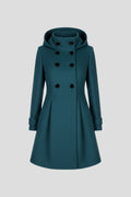 Woman wearing a green hooded double button-front coat - studio photo