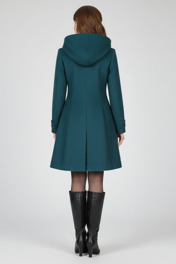 Woman wearing a navy blue hooded double button-front coat - studio photo