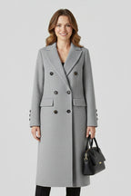 Woman wearing a grey lapel collar button-down coat - studio photo