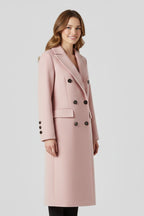 Woman wearing a pink lapel collar button-down coat - studio photo