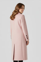 Woman wearing a pink lapel collar button-down coat - studio photo