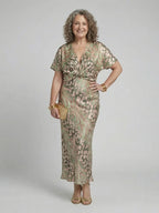 Woman wearing a gold abstract print v-neck twist-waist midi dress - studio photo