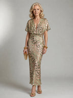 Woman wearing a green abstract print v-neck twist-waist midi dress - studio photo