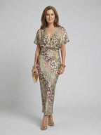 Woman wearing a green abstract print v-neck twist-waist midi dress - studio photo