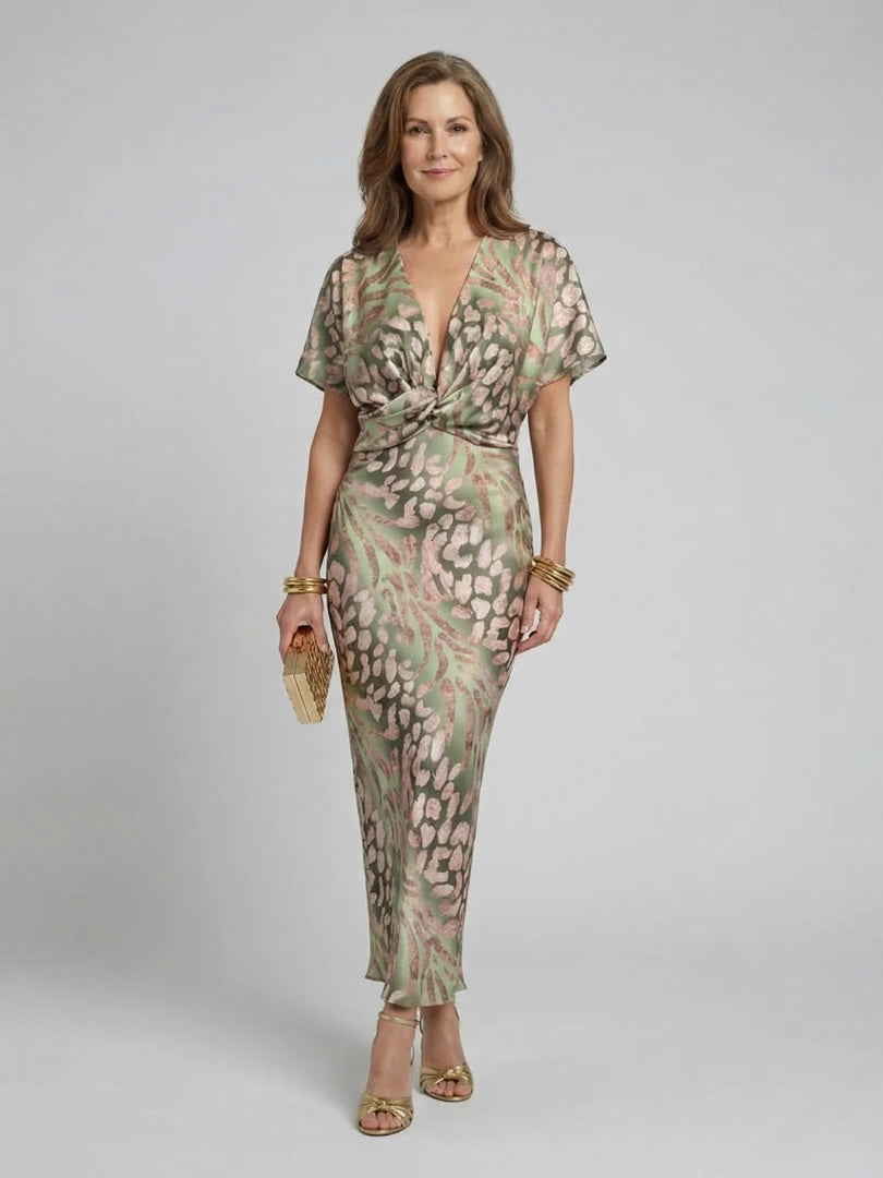 Woman wearing a green abstract print v-neck twist-waist midi dress - studio photo