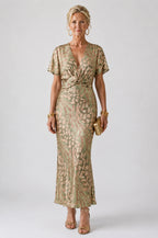 Woman wearing a green abstract print v-neck twist-waist midi dress - studio photo