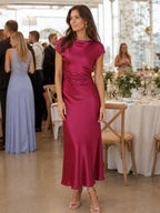 Woman wearing a burgundy boat neck short sleeve midi dress - editorial style photo