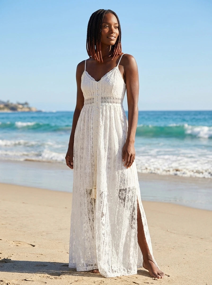 Woman wearing a white crochet lace boho maxi dress on a sunny beach