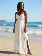Woman wearing a white crochet lace boho maxi dress on a sunny beach