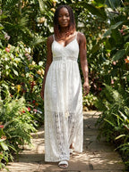Woman wearing a white crochet lace boho maxi dress in a garden setting