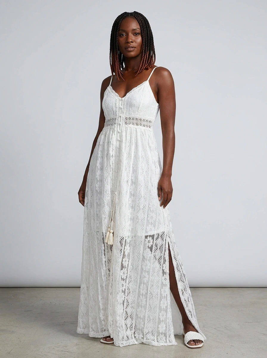 Woman wearing a white crochet lace boho maxi dress in a studio setting