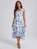 Woman wearing a blue and white floral print midi dress in a studio setting