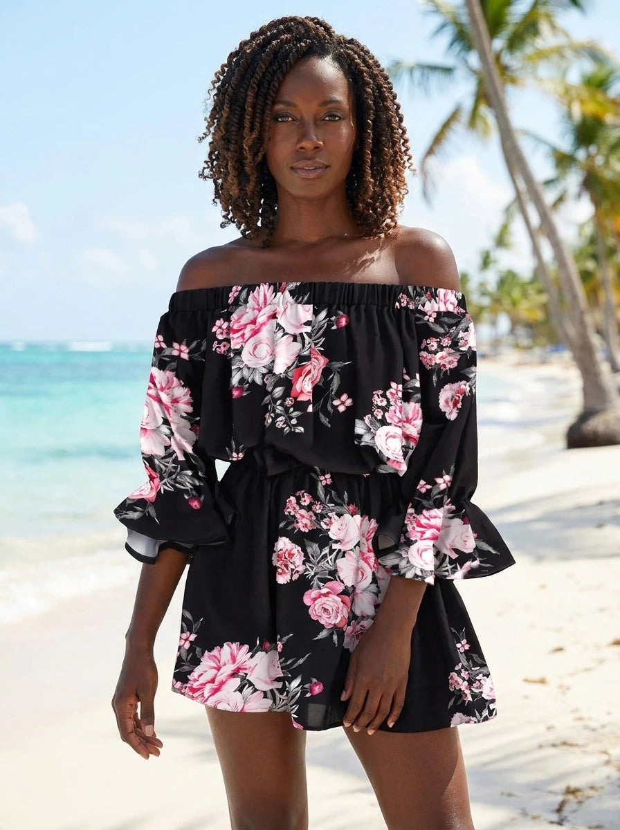 Woman wearing a black floral off-shoulder mini dress on a sunny tropical beach
