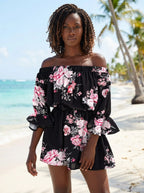 Woman wearing a black floral off-shoulder mini dress on a sunny tropical beach