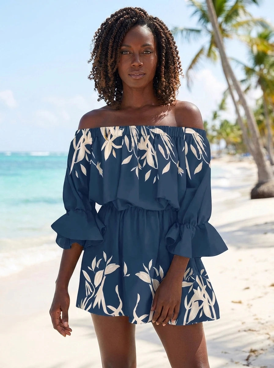 Woman wearing a navy blue floral off-shoulder mini dress on a tropical beach