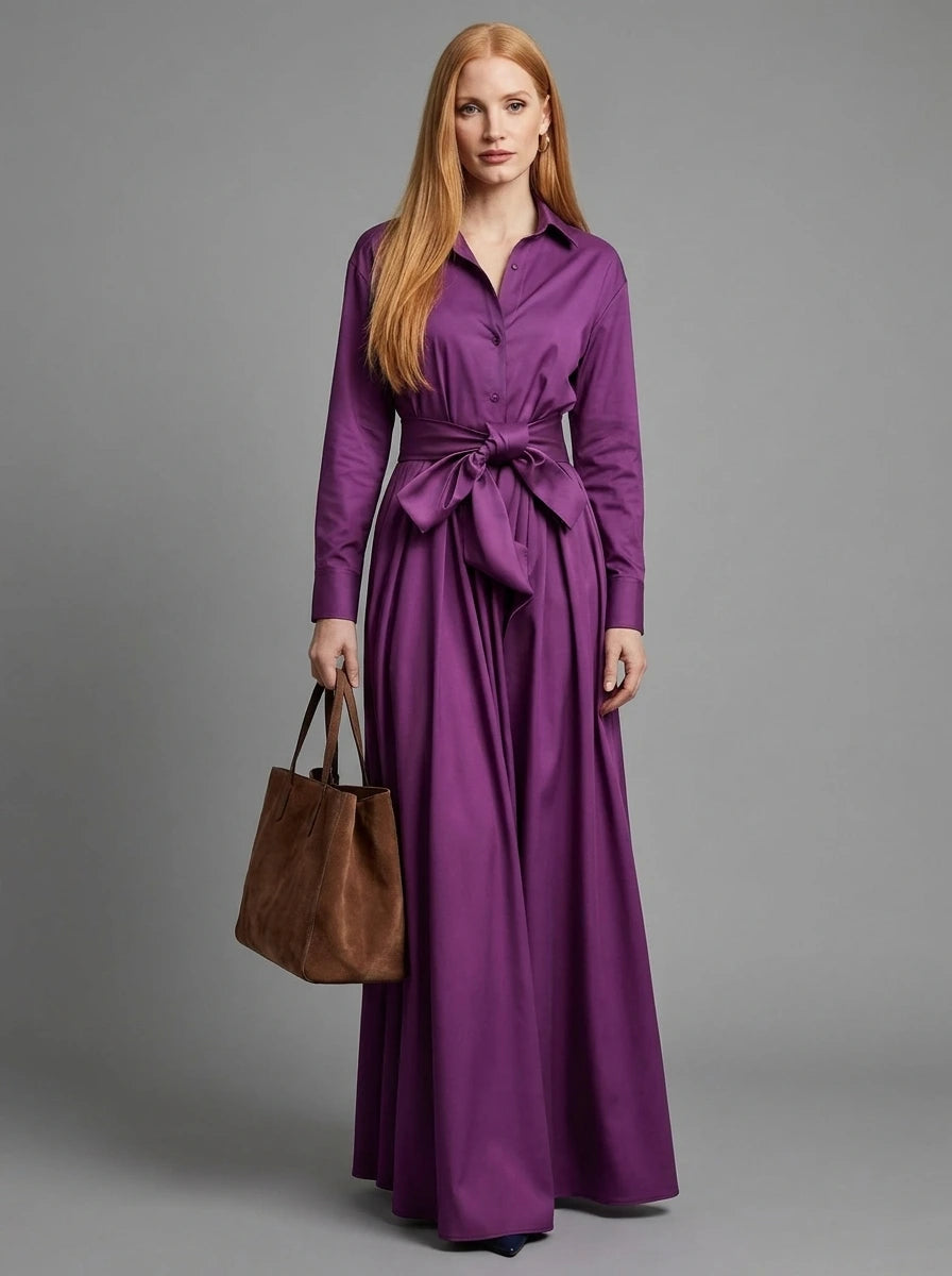 Woman wearing a purple bow detail maxi dress, studio photo