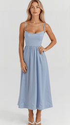 Woman wearing a light blue classic midi dress - studio photo