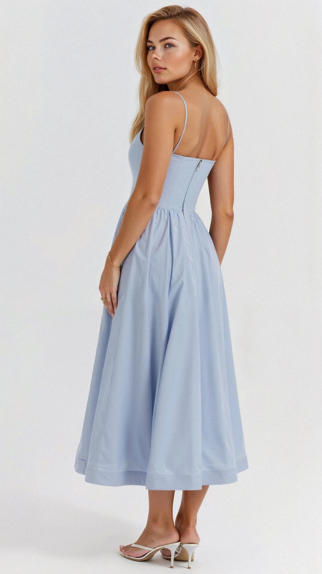 Woman wearing a light blue classic midi dress - studio photo