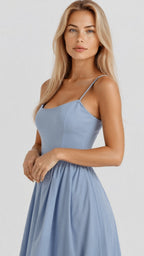 Woman wearing a light blue classic midi dress - studio photo
