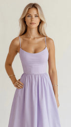 Woman wearing a purple classic midi dress - studio photo