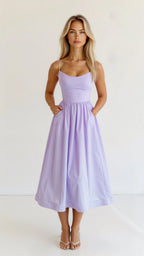 Woman wearing a purple classic midi dress - studio photo