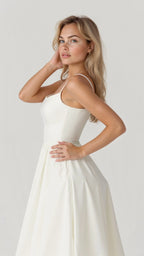 Woman wearing a white classic midi dress - studio photo