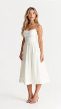 Woman wearing a white classic midi dress - studio photo
